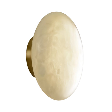 The Solenne LED Large Halo Alabaster Wall Light features a round, wall-mounted design with a smooth, soft white glass shade and a brass base, shown against a white background.