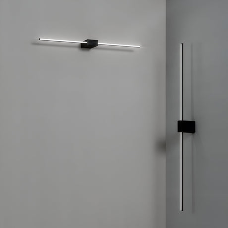 The minimalist wall lights from the Helion LED Picture Light collection adorn a grey surface, elevating contemporary interiors. A horizontal Helion LED Picture Light 13.5W 3000K - Black, 75cm is installed on the left wall, while a vertical one enhances the right. Each light showcases an elegant design with slender illuminated lines and a matte black finish for a modern touch.