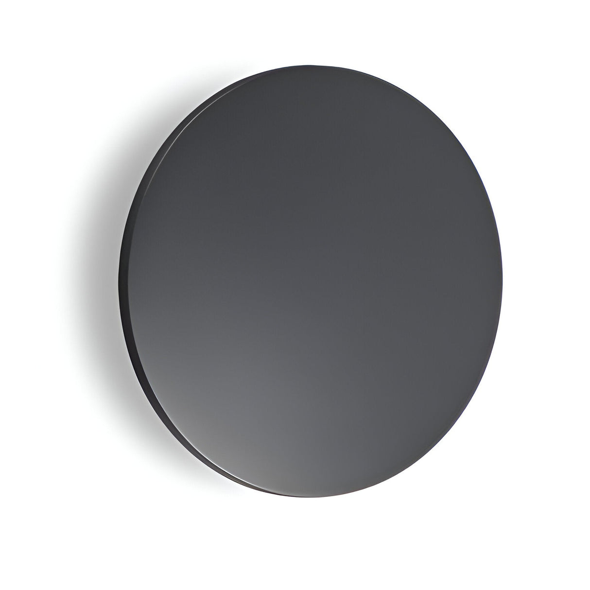 A sleek, round, black mirror hangs on a plain white wall, effortlessly complementing the minimalist, modern aesthetic. Nearby, an Eclipseax Outdoor LED Wall Light in grey softly illuminates the surroundings with its energy-efficient 9W 3000K warm glow at 18cm, adding subtle elegance to the scene.