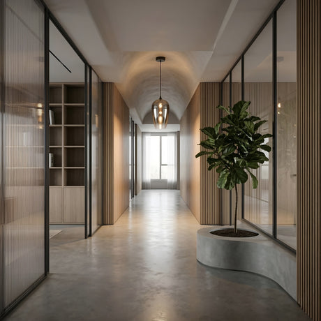 Modern hallway with glass office walls, wood paneling, a central potted plant in a curved planter, polished concrete floor, and a large window at the end illuminated by the Slice Glass Pendant Light - Chrome overhead.