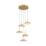 The Aurevia 5 Light LED Drop Alabaster Cluster Pendant Light in brushed brass features five circular alabaster lights suspended at varying lengths from a round ceiling mount by thin black wires, creating an elegant, modern look.