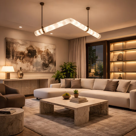 A modern living room with a large white sectional sofa, marble coffee table, abstract wall art, warm lighting from the Zareon LED Small Articulated Alabaster Suspension Light in soft white, indoor plants, built-in shelves, and floor-to-ceiling curtains.