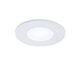 The Solix LED Recessed Downlight in white, featuring a 7W energy-efficient 3000K LED, is mounted on a white ceiling. It boasts a round, modern design with a minimalist touch and an illuminated central area encircled by a sleek frame.