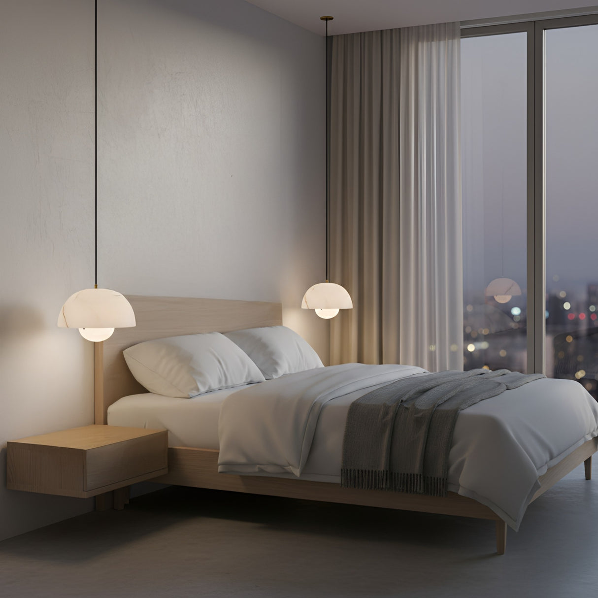 A modern minimalist bedroom features a light wood bed, white bedding, gray throw, floating nightstand, and the Elvara 1 Light Bowl Alabaster Single Pendant Light in Soft White & Brushed Brass. Floor-to-ceiling windows reveal city lights at dusk.