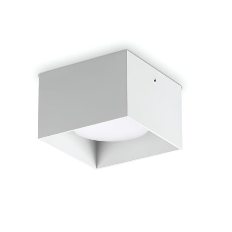 The Orbis Square Downlight - White is a minimalist ceiling fixture with a replaceable LED, featuring a square shape and modern design. Its clean edges and aluminum construction provide a streamlined appearance against its white background.