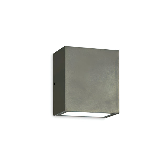 Introducing the Glaera Outdoor LED Wall Light 6W 4000K in Grey, featuring a minimalist rectangular design and a sleek metallic finish. Made from powder-coated die-cast aluminum, it is IP65 rated for superior weather resistance. Its smooth surfaces and subtle sheen are elegantly highlighted when mounted against a plain white background.