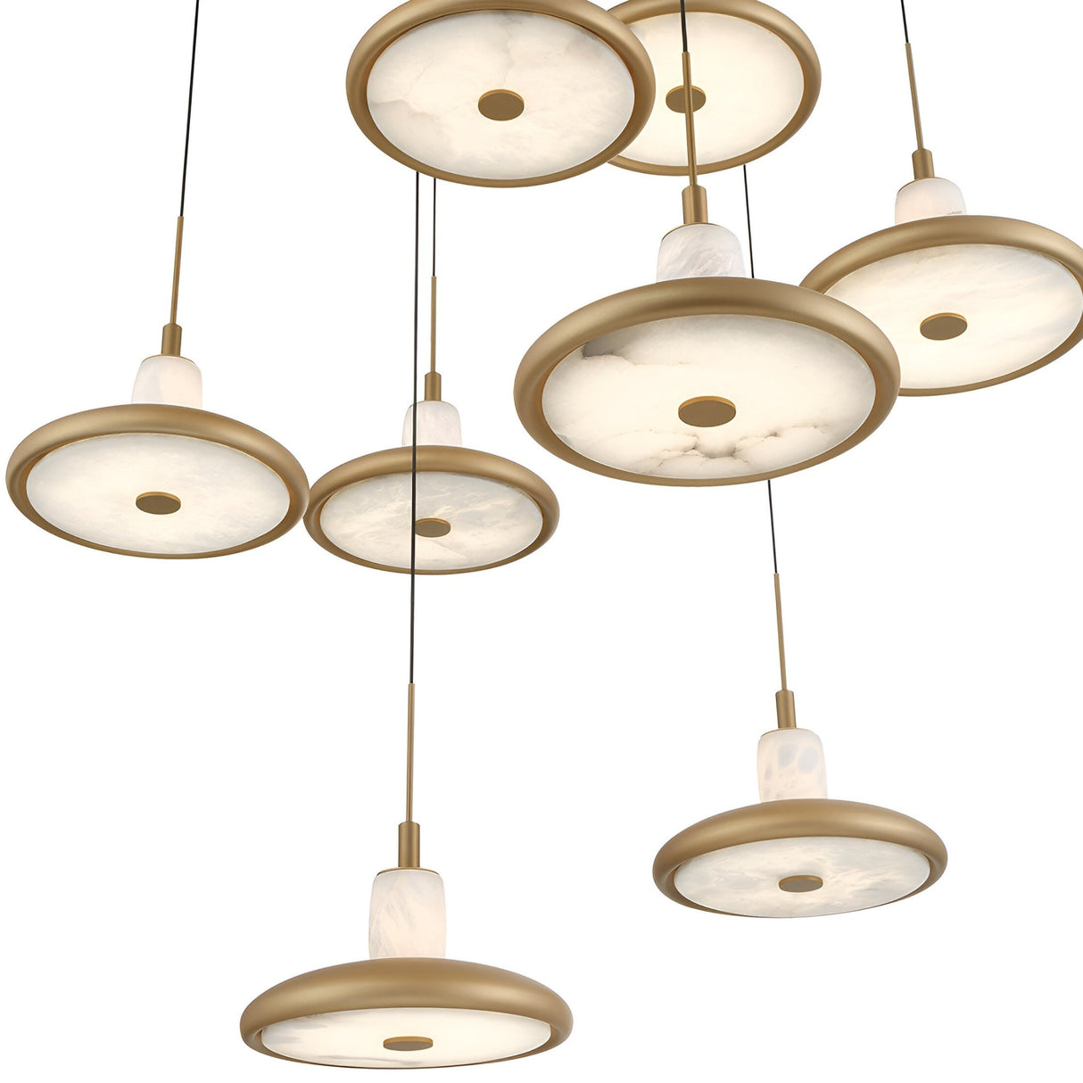 The Aurevia 5 Light LED Drop Alabaster Cluster Pendant Light in brushed brass features round, gold-rimmed marble-like white shades hanging at varied heights on black cords, offering a modern look.