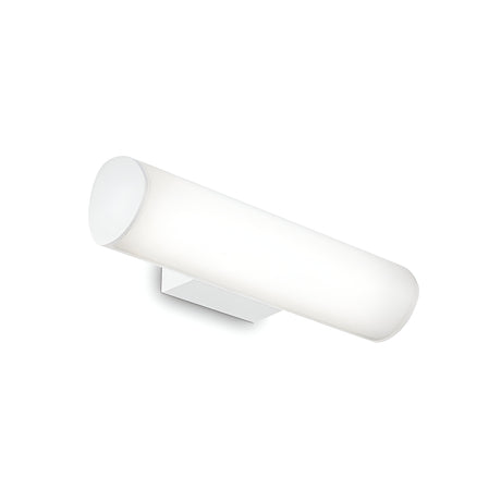 The Glintis LED Bathroom Mirror Light, with its minimalist design, features a cylindrical wall sconce in an energy-efficient LED setup. It boasts a sleek white matte finish and is mounted on a matching square base. The light emits a gentle diffused glow through the cylindrical cover, perfectly complementing the ambient illumination provided by the 9.5W 3000K mirror light.