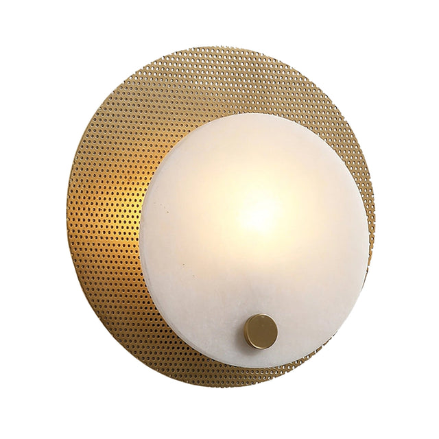 The Avelora LED Round Alabaster Wall Light features a soft white frosted glass shade set before a textured circular brass backplate, accented with a small brass knob at the bottom for added elegance.