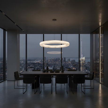A modern conference room with a long table, black chairs, and the Orbis Large LED Alabaster Semi-Flush Ceiling Light in Soft White features floor-to-ceiling windows showcasing a city skyline view at dusk.