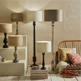 Captiva Grey Wash Mango Floor Lamp Base, 138cm, with turned wooden column and grey wash finish, shown among a lifestyle grouping of table and floor lamps in a living room setting.