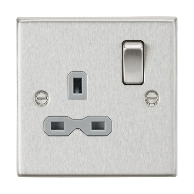 The 13A 1 Gang DP Switched Socket features a square metal design with a single switch on the right and a UK socket below a central screw. Its brushed chrome finish with grey insert and square edge design enhances the decor of any modern interior.