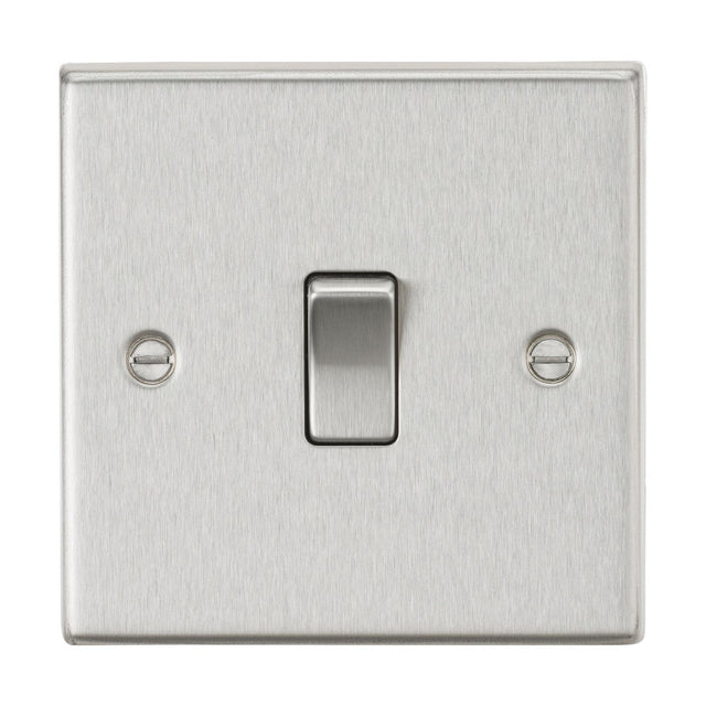 A 20A 1 Gang DP Switch - Brushed Chrome (Square Edge) is centered on the wall, featuring a single toggle in the middle. The brushed chrome plate has a sleek metallic finish, with two neatly aligned screws symmetrically placed on each side of the switch.