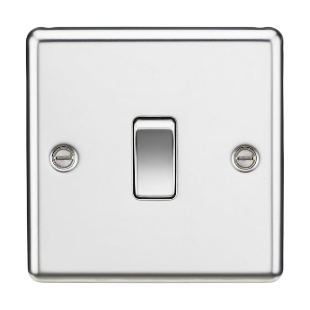 The 20A 1 Gang DP Switch in polished chrome, featuring a rounded edge design, takes center stage with its sleek metallic appearance. The glossy finish and centrally located switch, secured by two screws, enhance its elegance. Currently in the off position, it perfectly complements modern appliances such as water heaters.