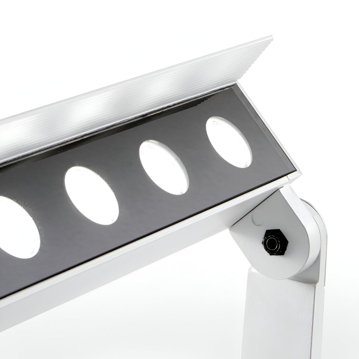 A close-up of the modern Alfaisis LED Outdoor Landscape Ground Light 18W 4000K displays its sleek design with round LED lights arranged diagonally within a white housing. This energy-efficient fixture features a minimalist aesthetic, an IP65 rating, and reflective surfaces with angular lines.