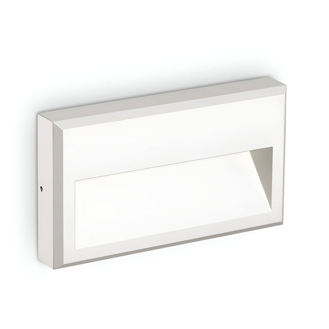 The Arcana-1 LED Outdoor Wall Light 6W 4000K in white is a minimalist rectangular fixture that features a cutout section for illumination, delivering energy-efficient brightness. With its clean lines and modern design, it mounts seamlessly against a plain white background.