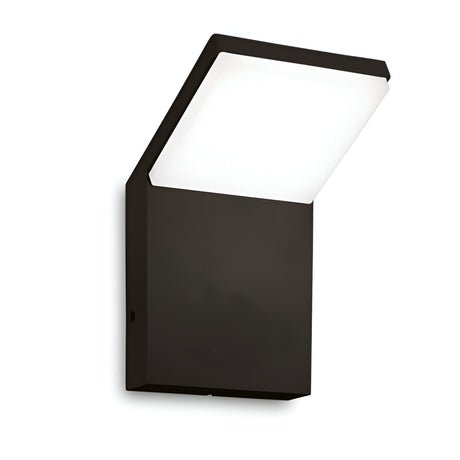 The Brillix Outdoor LED Wall Light 9W 3000K - Black is a modern, wall-mounted fixture featuring a square base and an angled rectangular light panel. Its minimalist and sleek design makes it ideal for contemporary lighting in both indoor and outdoor spaces.