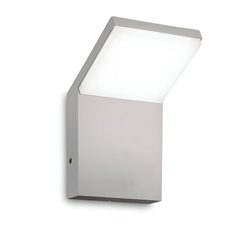 Introducing the Brillix Outdoor LED Wall Light 9W 3000K in Grey, featuring a minimalist and modern rectangular design. This energy-efficient fixture emits a soft white glow with its outward-tilted light panel.