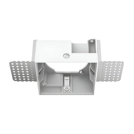 A white electrical wall box with side wings featuring perforated holes, designed for in-wall installation, is enhanced by the modern design of a Glistenis Large Trimless Square Frame For Downlight - White. The box also includes internal compartments and a central opening on top.