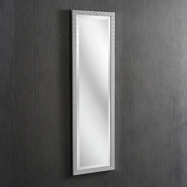 The Frost Rectangle Wall Mirror in silver hangs on a vertically striped gray wall, featuring a textured frame that adds an elegant touch to complement the minimalist design and modern luxury of the interior.