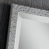 The Frost Rectangle Wall Mirror - Silver features a close-up view highlighting its superior craftsmanship with a textured, reflective grid pattern. Set against a dark, textured wall backdrop, the mirror's gleaming silver frame exudes modern luxury through its rectangular form.