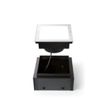 Introducing the Zephyra LED Square Recessed Ground Light - 16W, 3000K in Silver. This robust fixture is designed to blend seamlessly into outdoor surfaces, showcasing an open square frame and visible wiring. Its durable steel housing ensures longevity and a dependable cable guarantees secure electrical connection, making it perfect for outdoor illumination needs.