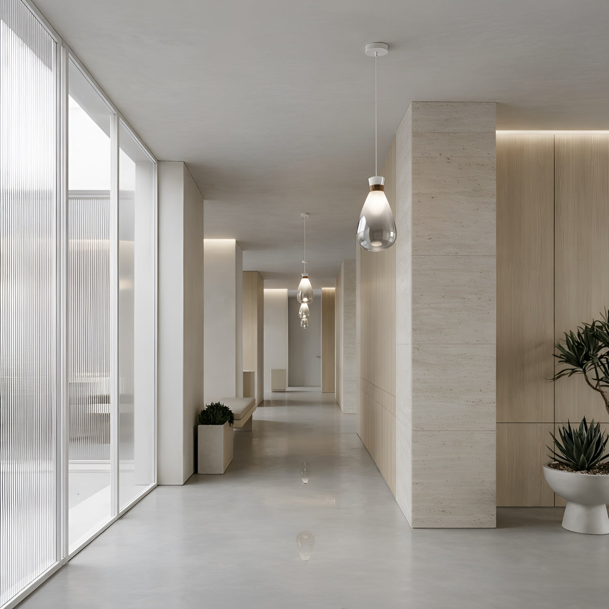 A modern hallway with light wood paneling, large frosted windows, potted plants, and neutral flooring features a bright, open feel enhanced by the Soffi Small Glass Pendant Light - Clear for a clean minimalist look.