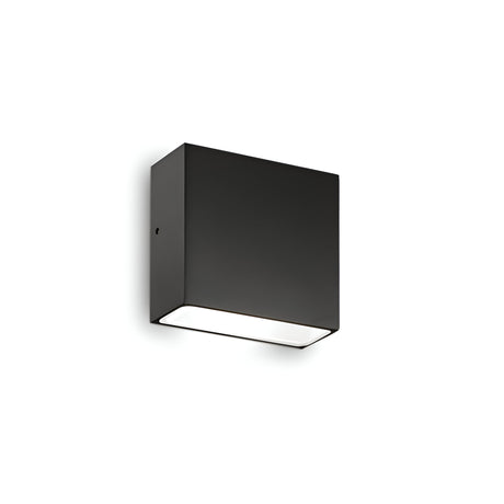 The Sparka-1 Outdoor Wall Light - Black is a contemporary and minimalist rectangular fixture with an IP44 rating. It features a sleek design that emits light from the bottom, beautifully showcased against a white background.