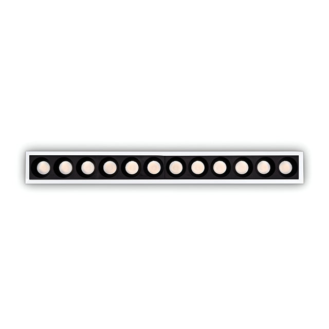 The Phosix Slim LED Recessed Downlight, a sleek white fixture equipped with 10W power and emitting a warm 3000K glow, blends modern style with energy-efficient lighting through its circular lights softly illuminating the space against a contrasting black background.