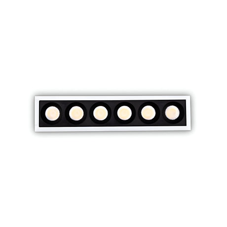 The Phosix Slim LED Recessed Downlight - 20W, 3000K, White boasts a minimalist design with six round LED downlights arranged in a row. These are set within a black frame featuring a white border, providing energy-efficient lighting with a warm glow.