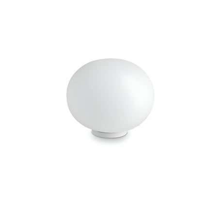 The Orlix Medium Table Lamp - White showcases a smooth, spherical form and minimalist design. Its acid-etched glass diffuser beautifully complements the simple base, elegantly set against a white backdrop.