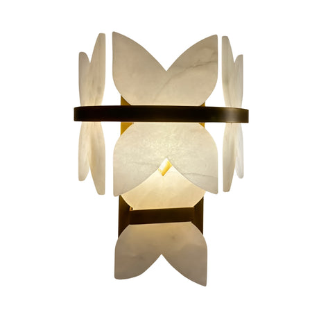 The Petraia LED Floral Alabaster Wall Light features hand-carved Spanish alabaster petals and a brushed brass band, emitting a warm, soft glow in any space.