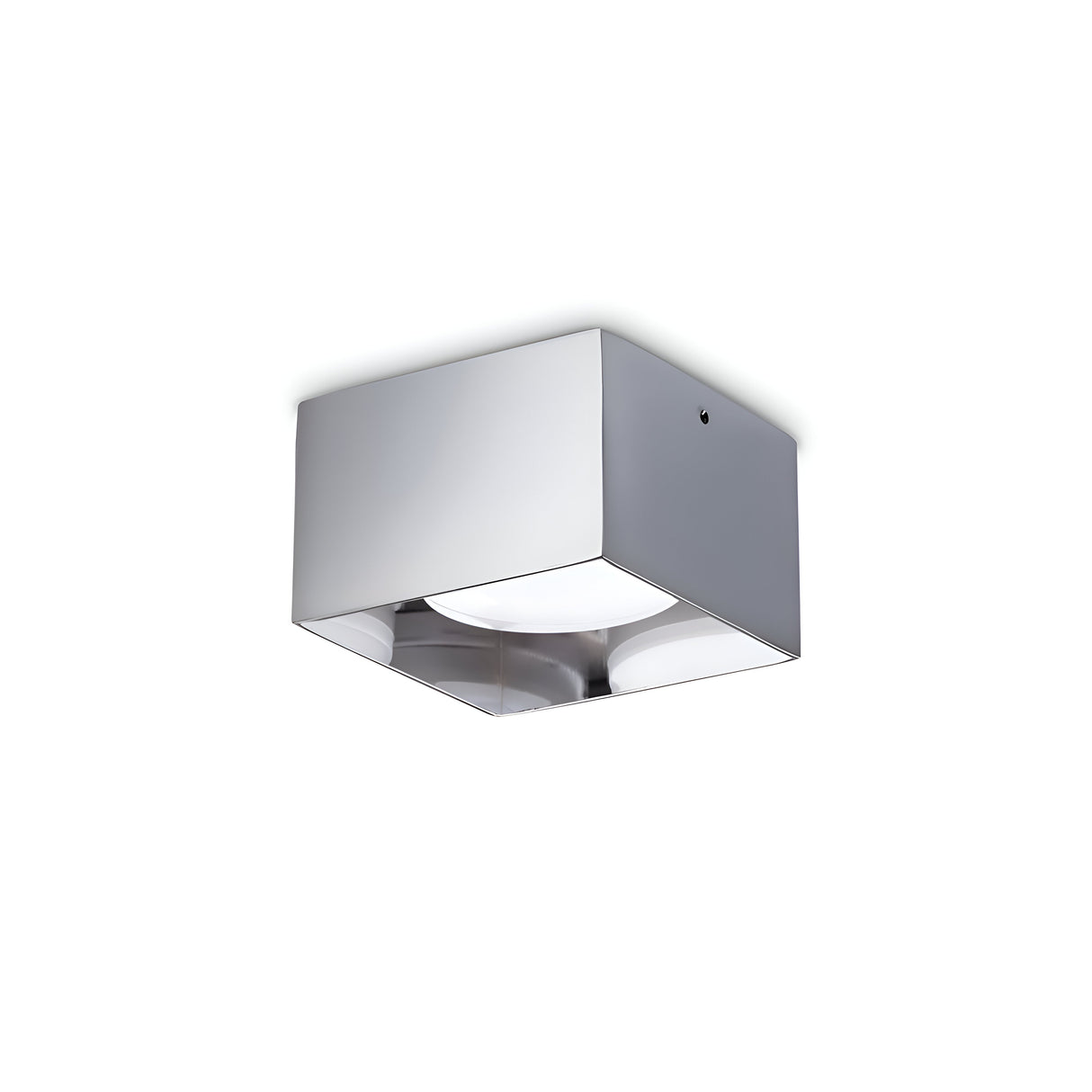 The Orbis Square Downlight - Chrome is a minimalist ceiling light fixture with a sleek, metallic chrome finish and a frosted glass bottom. It is equipped with an LED light source to evenly distribute soft, ambient lighting in modern interiors.