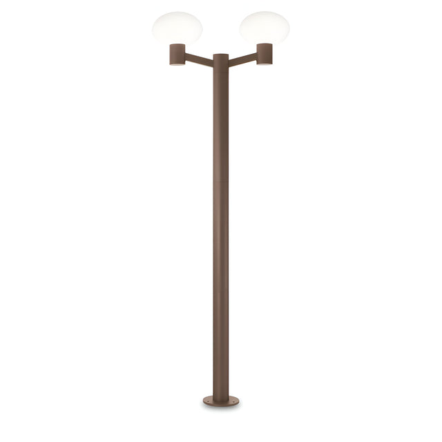 The Photonix Twin Head Lamp Post - Brown boasts a modern design with a sleek, brown pole and two symmetrical, white glowing lights at its peak. This contemporary outdoor lamp post is showcased against a plain white backdrop, providing ambient lighting that enriches any environment.