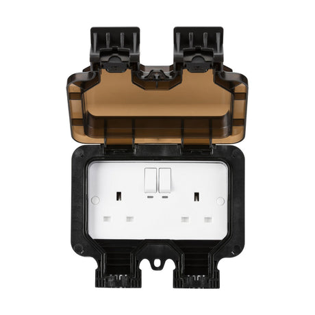 The Smart IP66 13A 2 Gang Outdoor Socket features a protective black and brown cover, which is open to display a smart double plug outlet with two switches. This weatherproof unit is specifically designed for outdoor use and includes power monitoring for enhanced convenience.