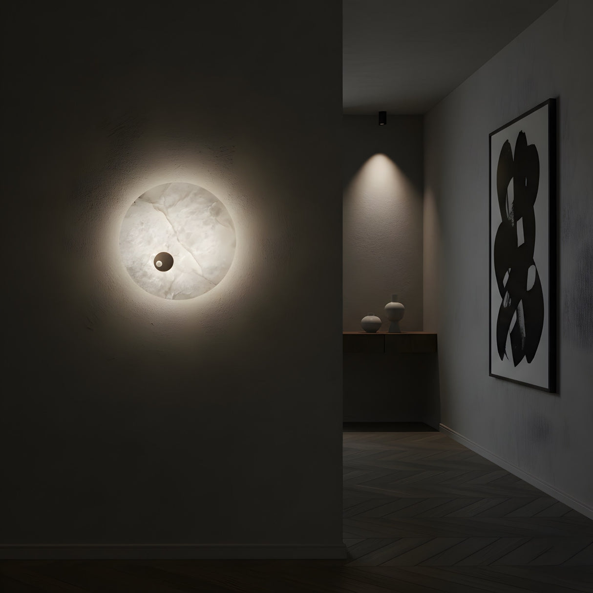 A minimalist interior features the Selvana LED Small Alabaster Wall Light - Soft White casting a gentle glow, an abstract black-and-white painting on the wall, and a console table with two vases in the background.