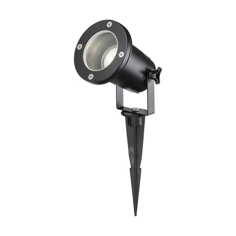 The IP65 GU10 Ground Spike - Black boasts a black metal casing and bracket, effortlessly mounted on an IP65 garden spike to ensure durability. The light directs upward with a circular lens, featuring intricate screw details on the rim for optimal outdoor performance.