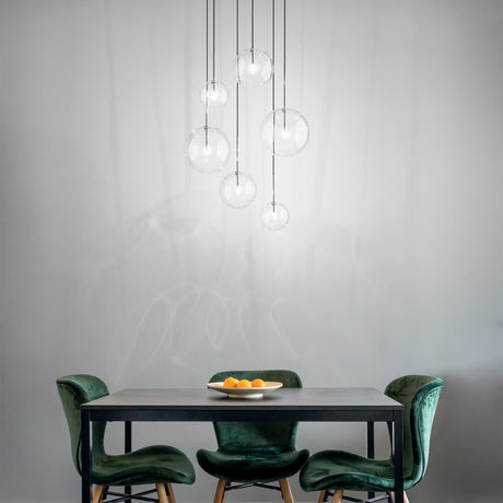 Equinoxe amber glass globe chandelier over a dining table