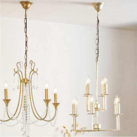 Giry multi-arm chandelier pendant light in antique silver metal, shown right, with candle-style arms and exposed bulbs, hung beside a gold chandelier in a room setting.