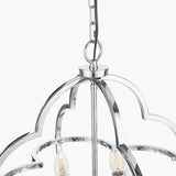 Close-up of the Amine Chrome 4 Light Fleur De Lys Pendant, showing the chrome ceiling canopy, chain link, and curved arched frame with candle-style bulbs, on a white background.