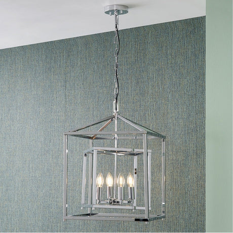 Anis Nickel 4 Light Cube Pendant, 40cm, an open square cage design with candle-style bulbs on a chain, hanging in a room with teal textured walls.