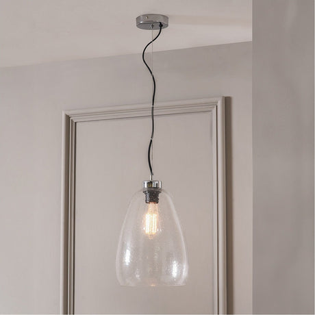 Beja Organic Shape Tall Clear Bubble Glass Pendant Light, 22cm, with chrome fittings and black cord, hung above a doorway in a light-coloured room.