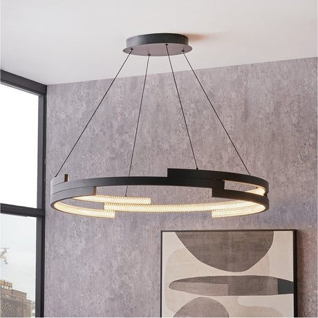Sienna Black Iron LED Ring Pendant Light, 82cm, a single circular ring fixture with acrylic diffuser suspended on black cables in a room with grey textured walls.