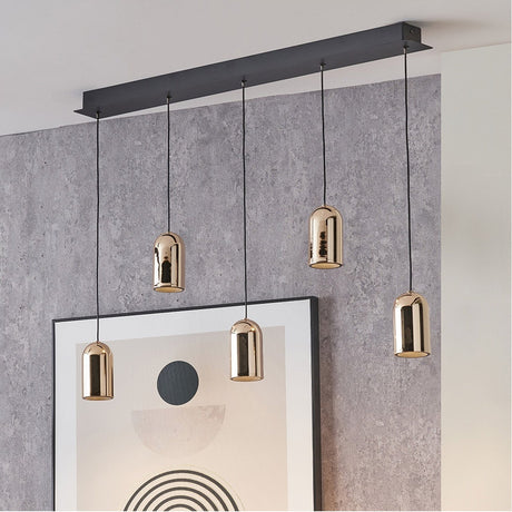 Xena Black & Rose Gold Iron 5 Drop LED Pendant Light, 81cm black bar with five staggered rose gold dome shades, shown against a grey textured wall.