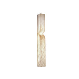 A tall, rectangular, cream-colored stone sculpture with a gentle inward center curve resembles the Vera LED Small Silhouette Alabaster Wall Light – Soft White, set upright against a plain white background.