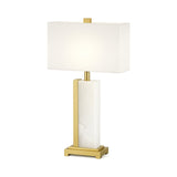 The Silvarin 1 Light Sculpted Alabaster Table Lamp in brass and soft white features a geometric alabaster base with white and gold accents and a rectangular white shade, displayed against a plain white background.
