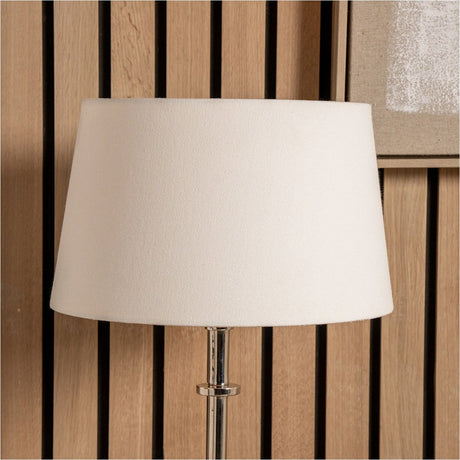 Winston White Handloom Tapered Lampshade, 45cm, in white fabric with a tapered shape, shown fitted on a chrome lamp base against a wood-slatted wall.