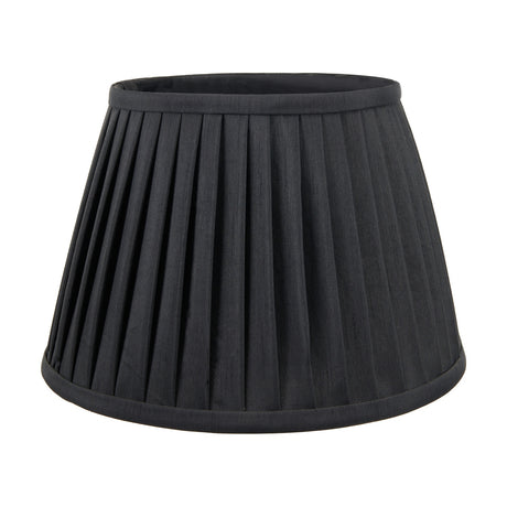 Lyndon Black Silk Mix Knife Pleated Tapered Lampshade, 25cm, in black fabric with fine vertical pleats and a bound trim edge, shown on a plain white background.