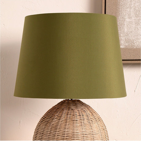 Adelaide Sage Tapered Cotton Mix Lampshade, 35cm, in sage green fabric with a tapered drum shape, shown fitted on a woven rattan base lamp.