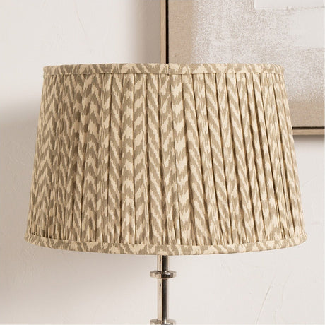 Vienna Taupe Chevron Pleated Lampshade, 45cm wide drum shape with pleated fabric in taupe and cream chevron pattern, shown fitted on a chrome table lamp base.